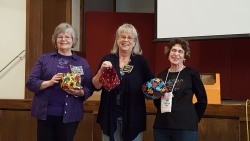 Wilma Wine, Norma Womack and Marilyn John showing off Serger Group project