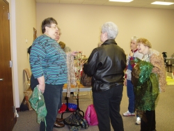 Shirley Binder, Theresa Corle, Barbara Bohm & Mary Ann Esch admiring Lori Postlethwait's lace scarves.