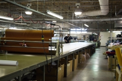 Laying the marker on the fabric, getting ready for cutting