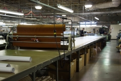 Laying the marker on the fabric, getting ready for cutting